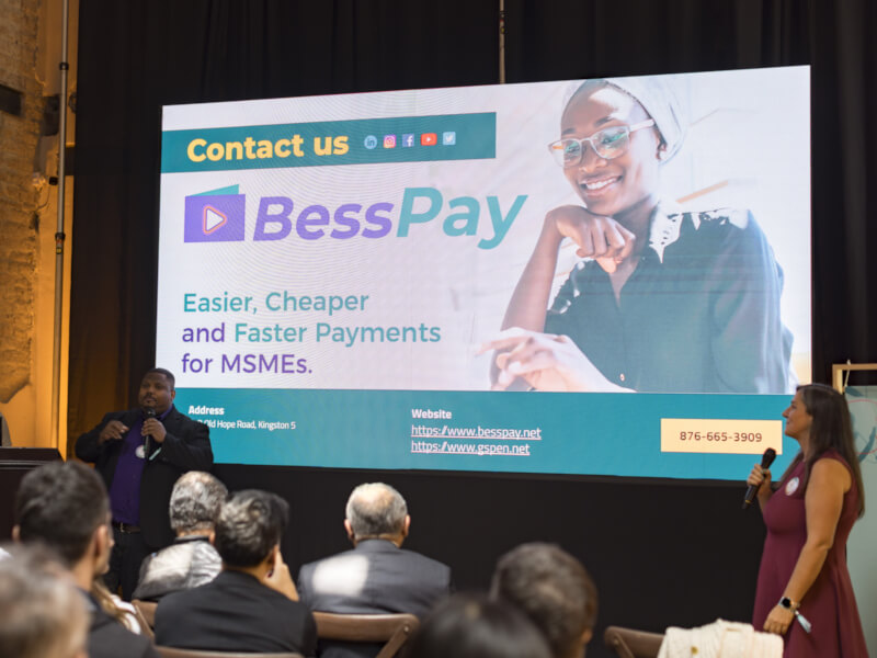 Douglas Davidson, co-founder of BessPay, presenting in front of a screen displaying the text: ‘BessPay – Easier, Cheaper and Faster Payments for MSMEs.’